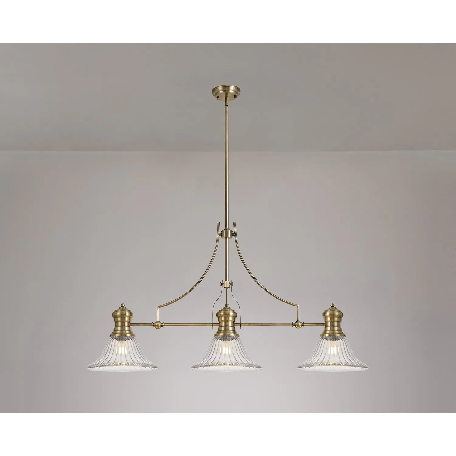 Sandy 3 Light Linear Pendant E27 With 30cm Bell Glass Shade, Antique Brass, Clear